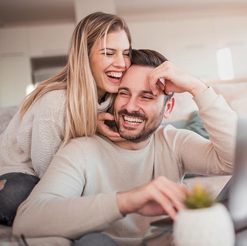 couple at home laughing